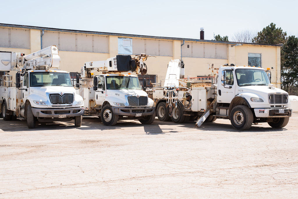 Fairway Electrical trucks and equipment showcasing the real-world construction industry background that inspired Tradetraks